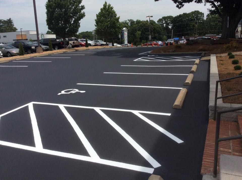 A parking lot with a handicap sign painted on it
