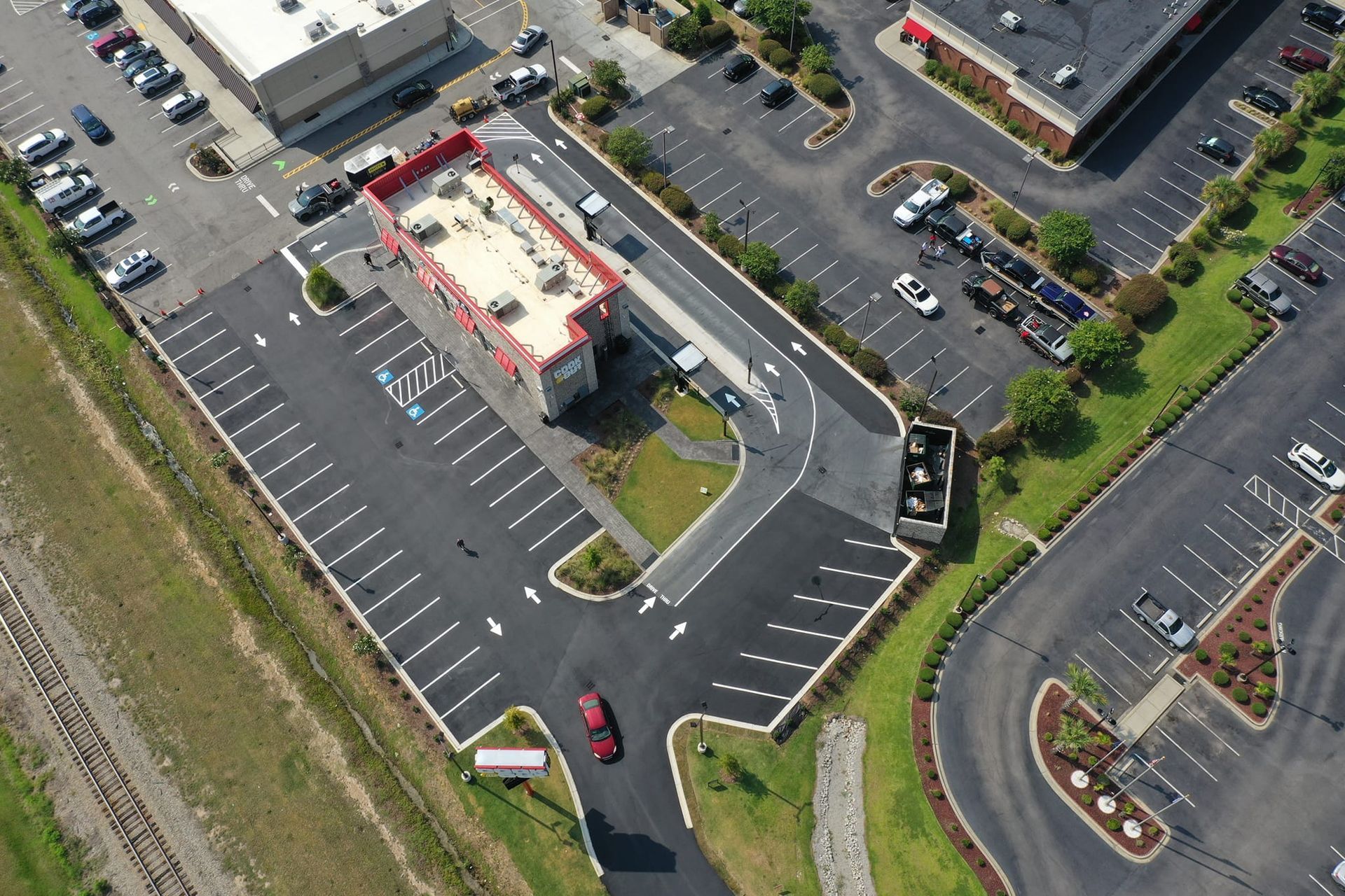 An aerial view of a parking lot with cars parked in it