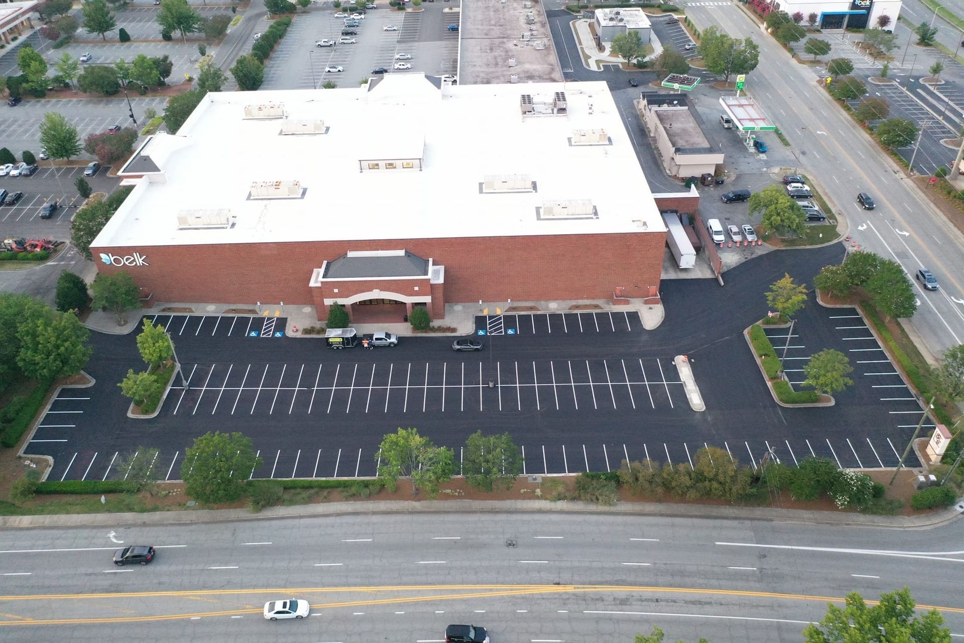 An aerial view of a large building with a parking lot in front of it