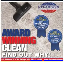 Ad for Steamatic carpet cleaning: vacuum on rug with award ribbons, contact info.