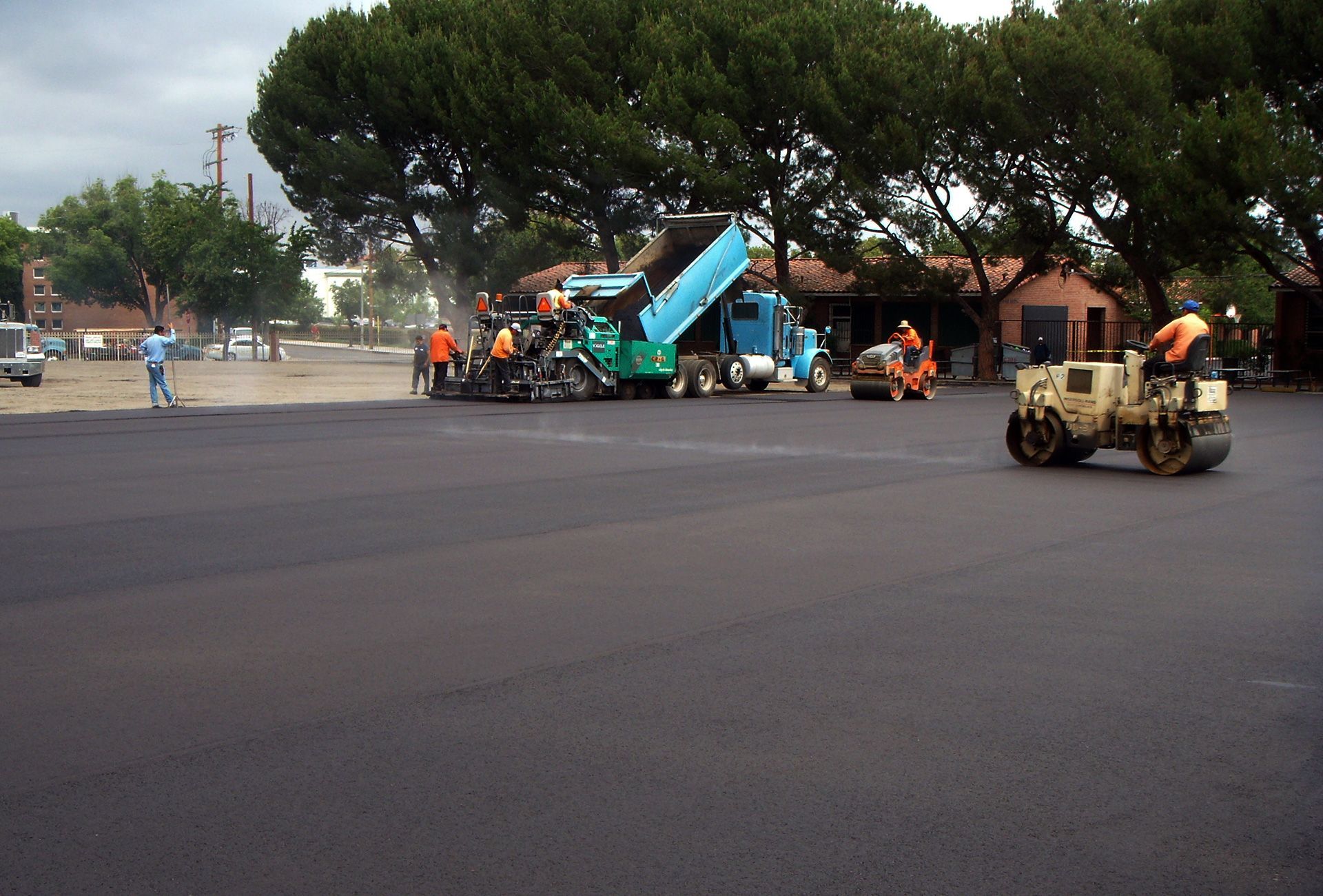 A group of construction workers are working on a road