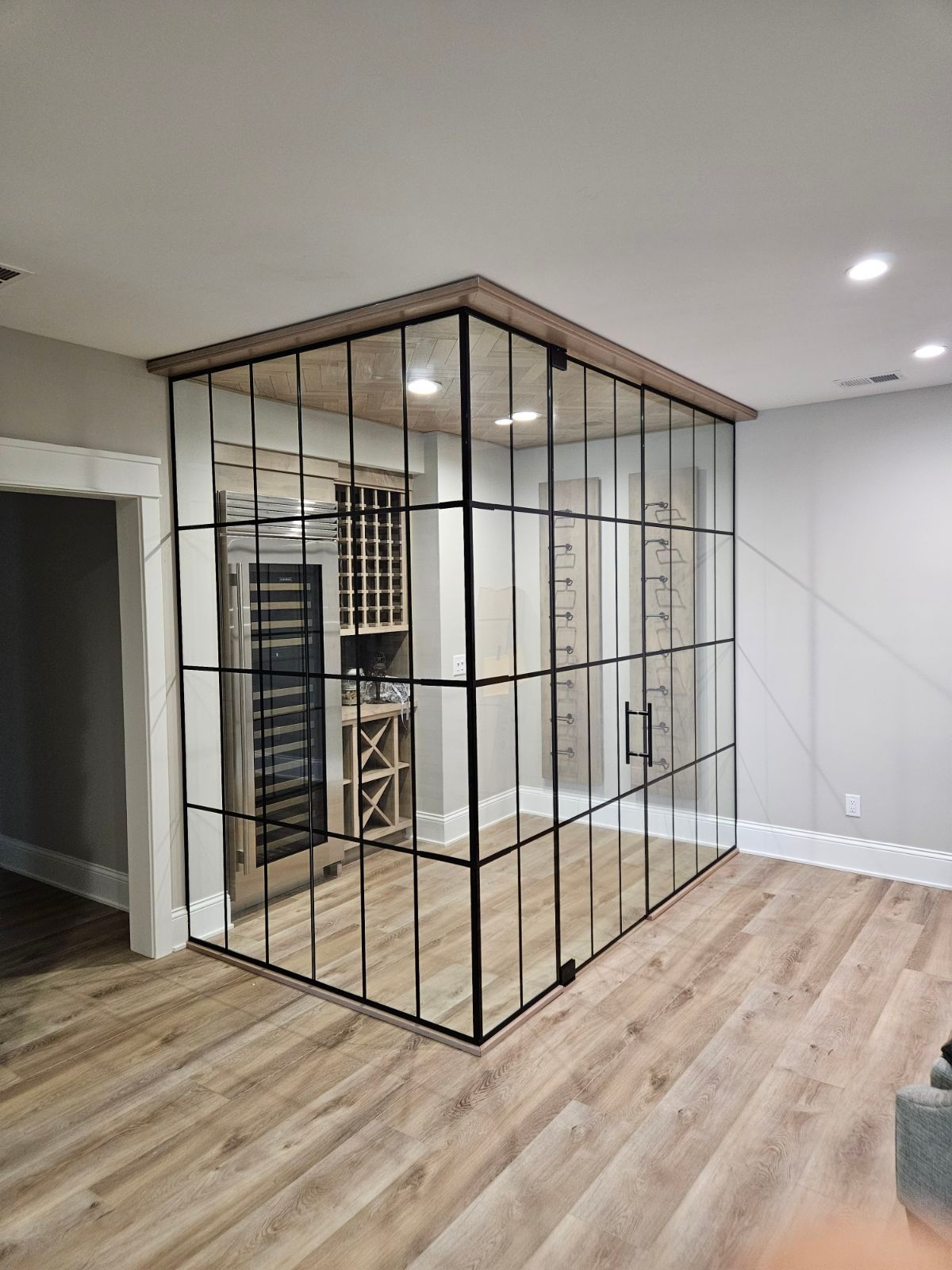 A piano with a glass cover in a living room.