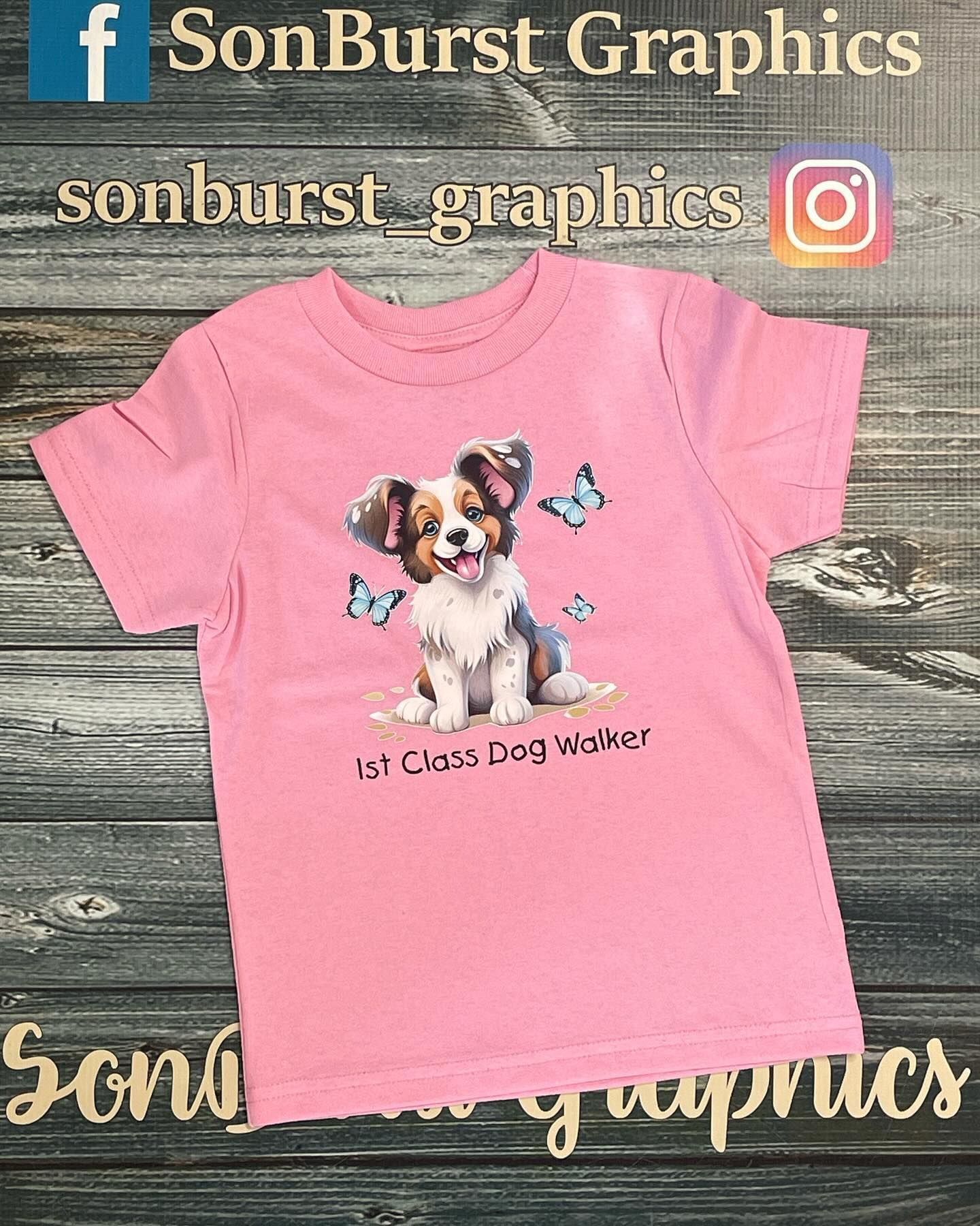 A pink t-shirt with a picture of a dog and butterflies on it.