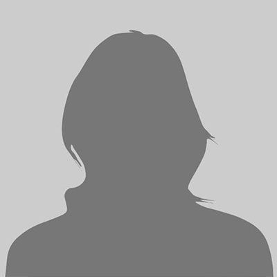 Silhouette of a person with short hair and a high collar, set against a gray background.
