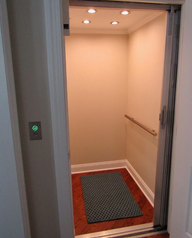 Interior of a small home elevator with beige walls