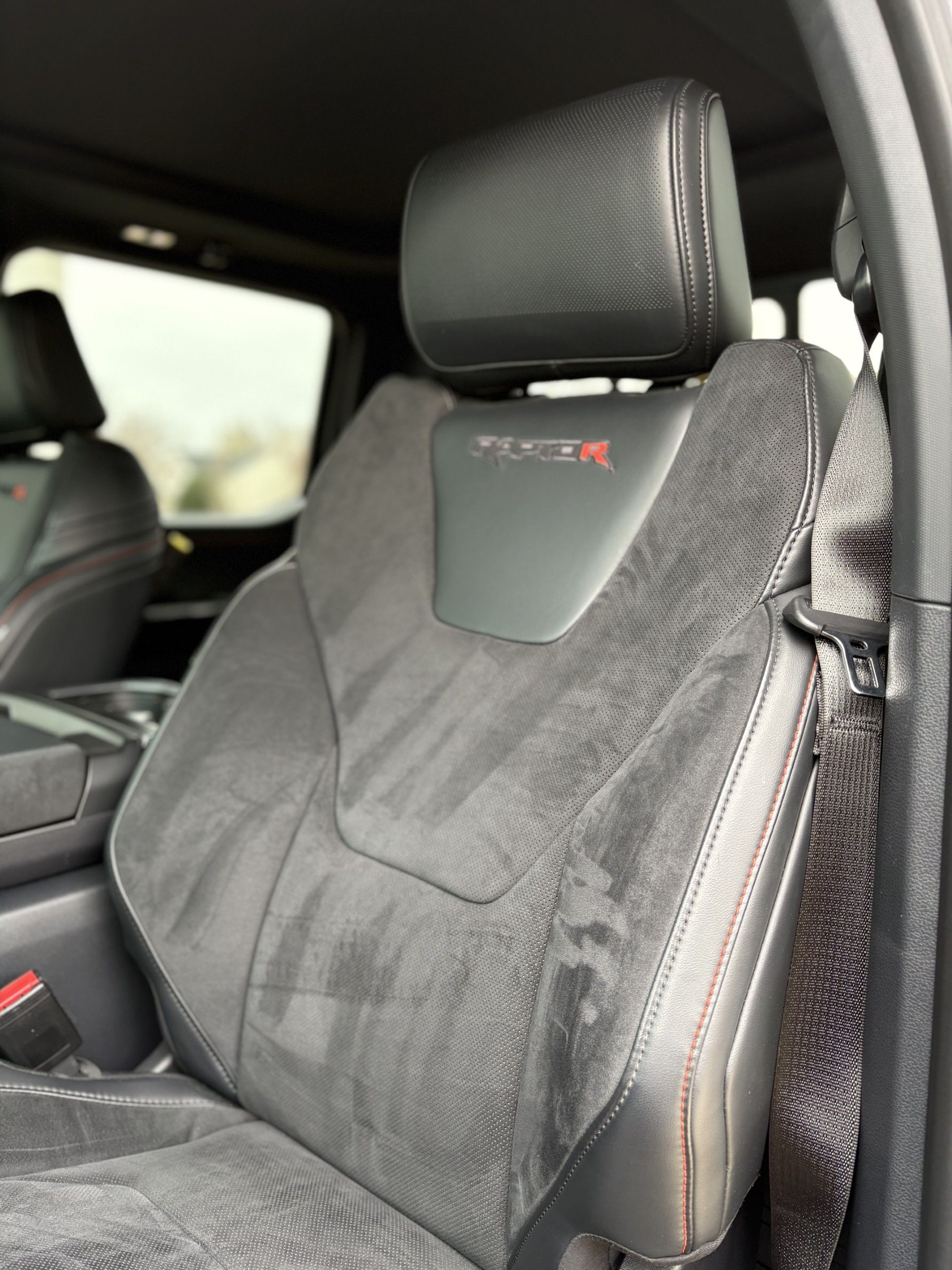Black car seat with suede inserts, 