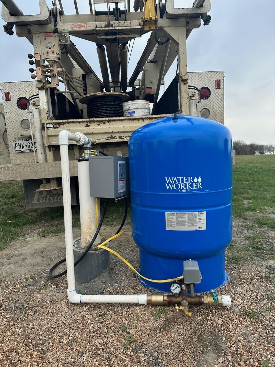 A blue water storage tank labeled