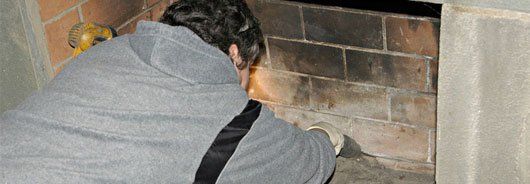 Man cleaning fireplace