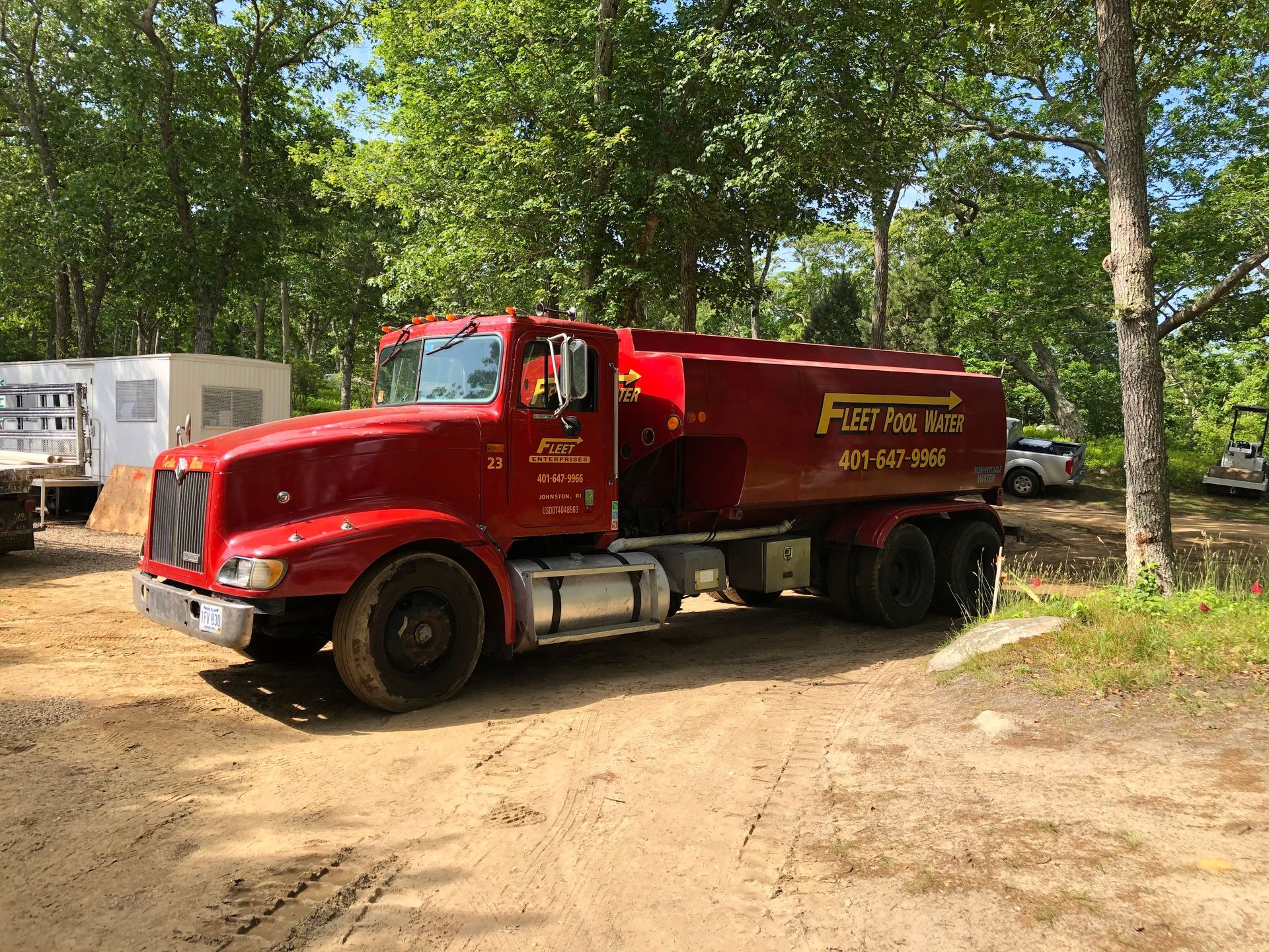Fleet Water Delivery red truck left front body side view