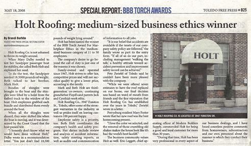 Newspaper article about Holt Roofing winning the medium-sized business ethics award. The article has a picture of the Holt business.