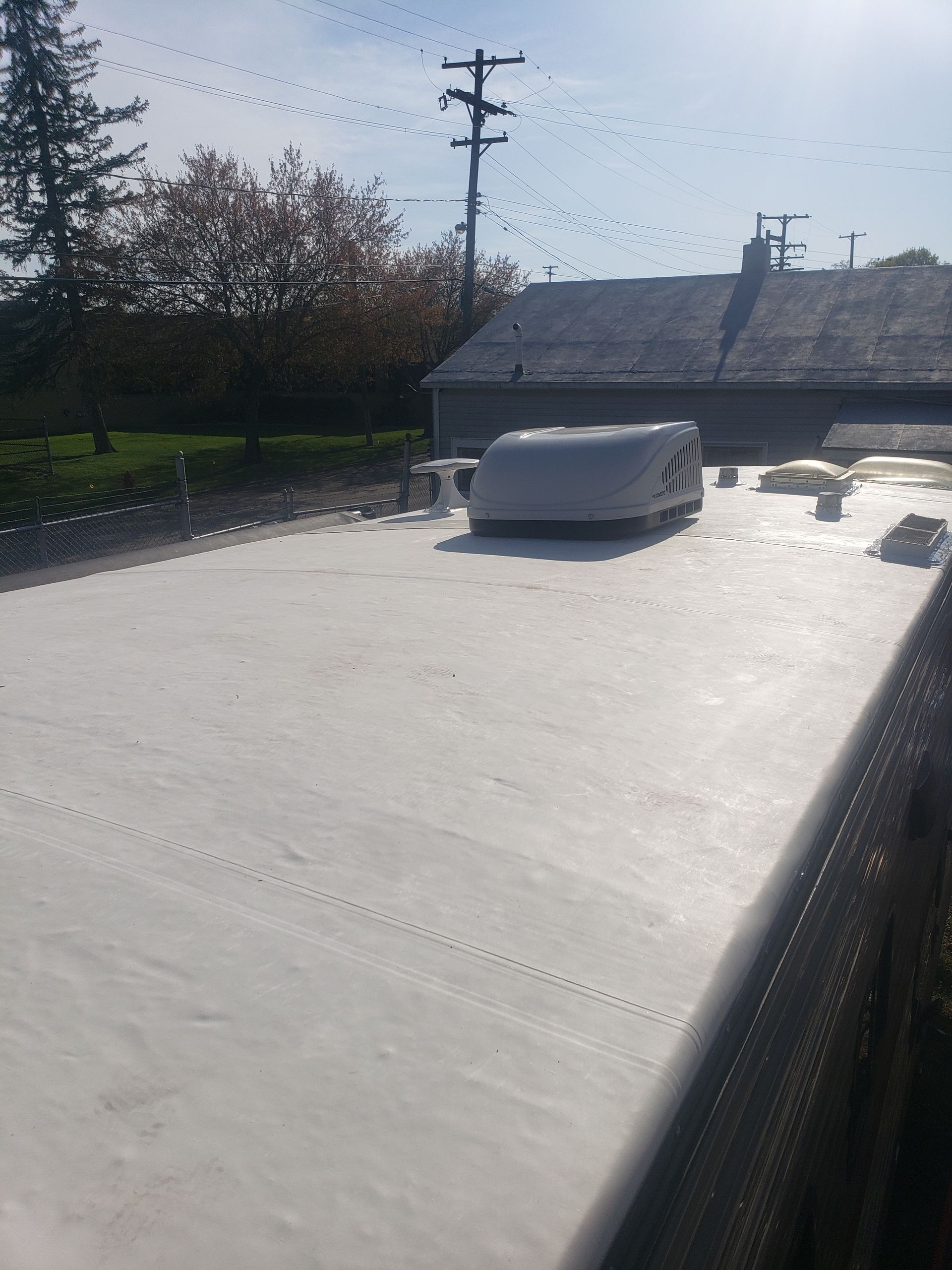 A white van is parked on the roof of a house