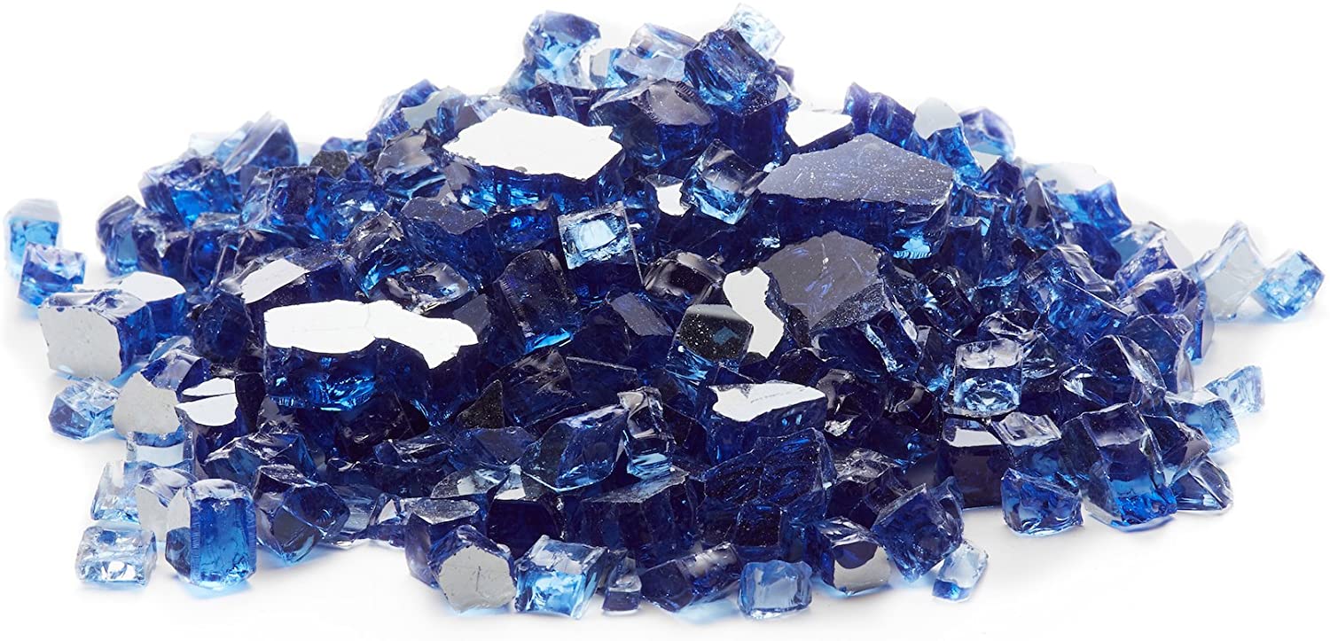a pile of blue glass rocks on a white background .
