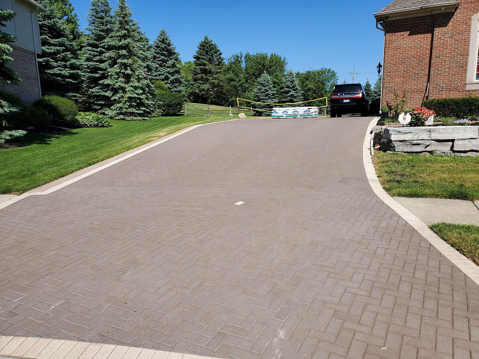 A car is parked in the driveway of a house.