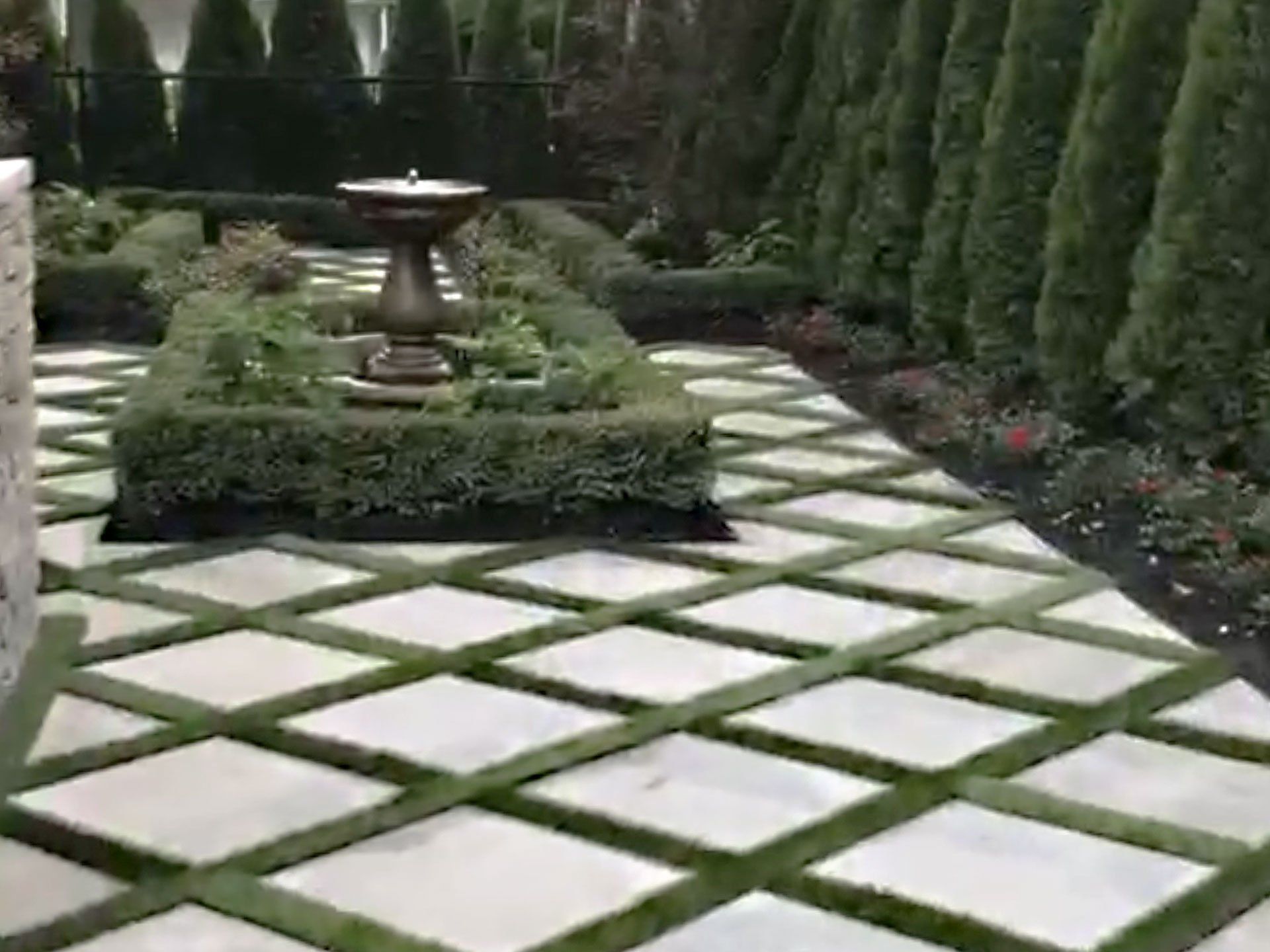 There is a fountain in the middle of the garden.