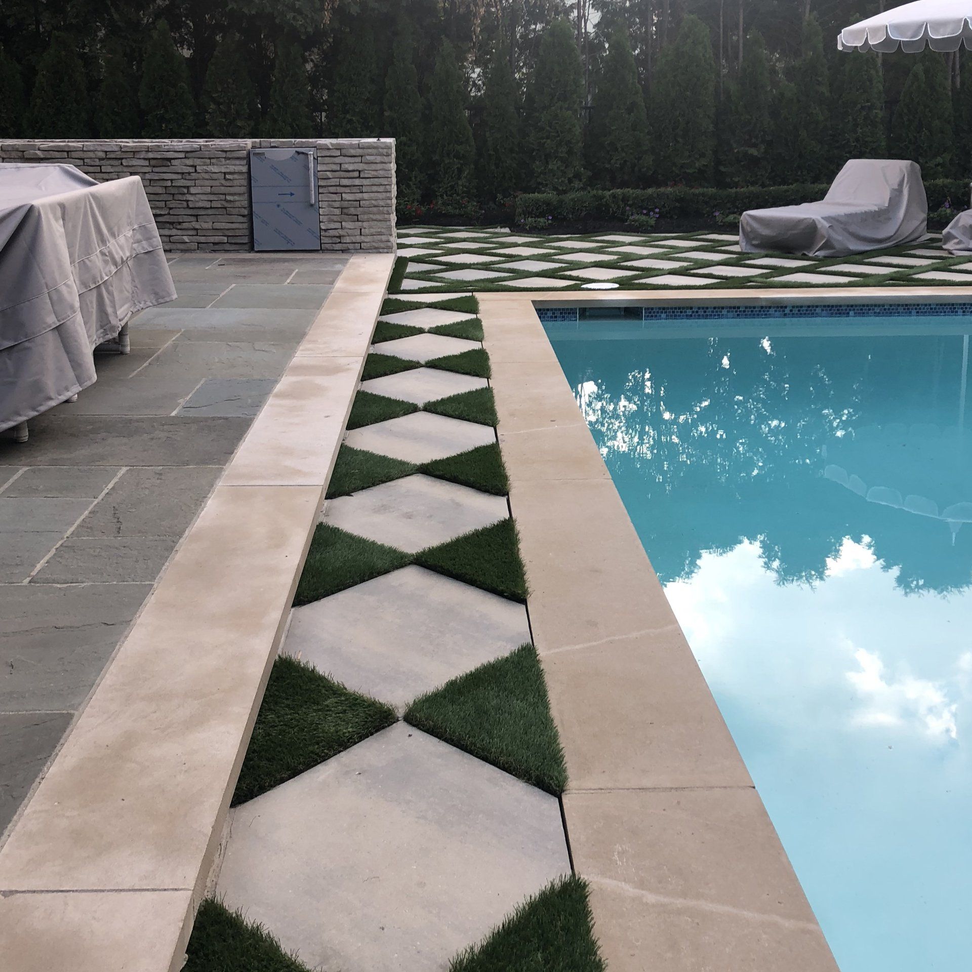 A swimming pool with a walkway leading to it