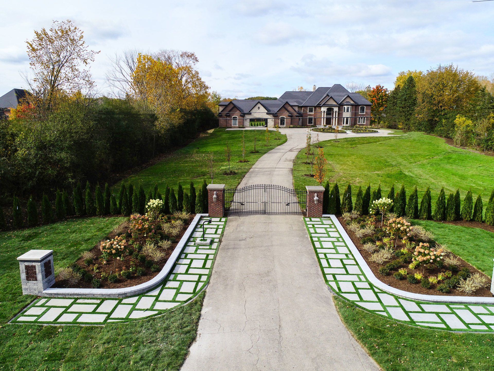 An aerial view of a driveway leading to a large house.