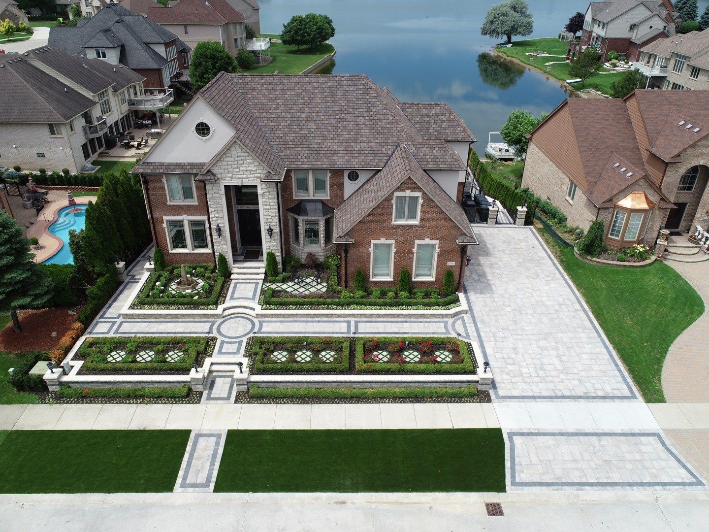 An aerial view of a house with a large driveway