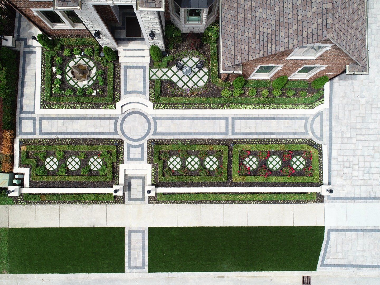An aerial view of a house with a garden in front of it.