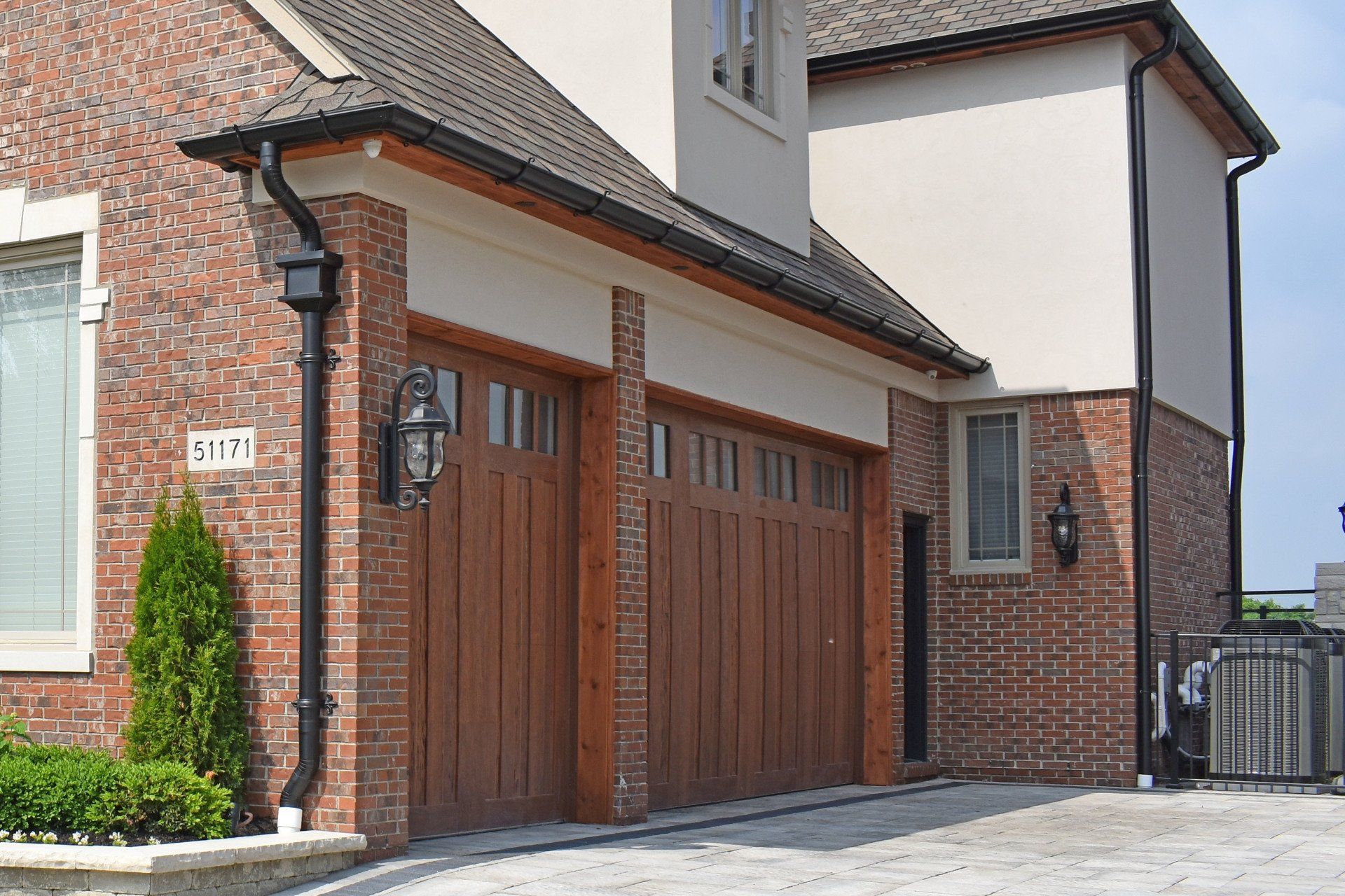 A large brick house with a wooden garage door