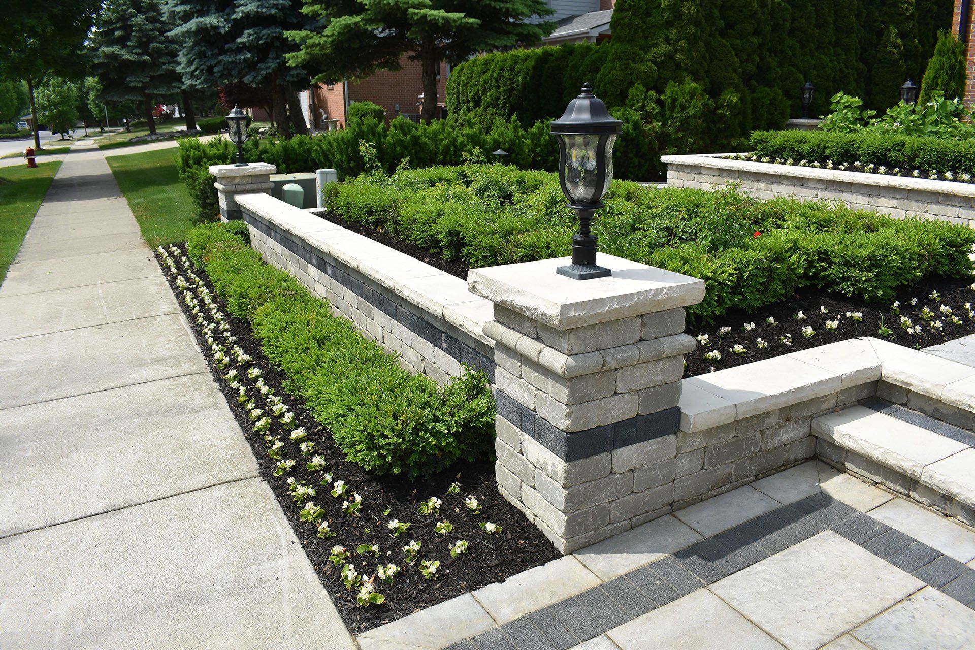 A brick wall with a lamp on top of it
