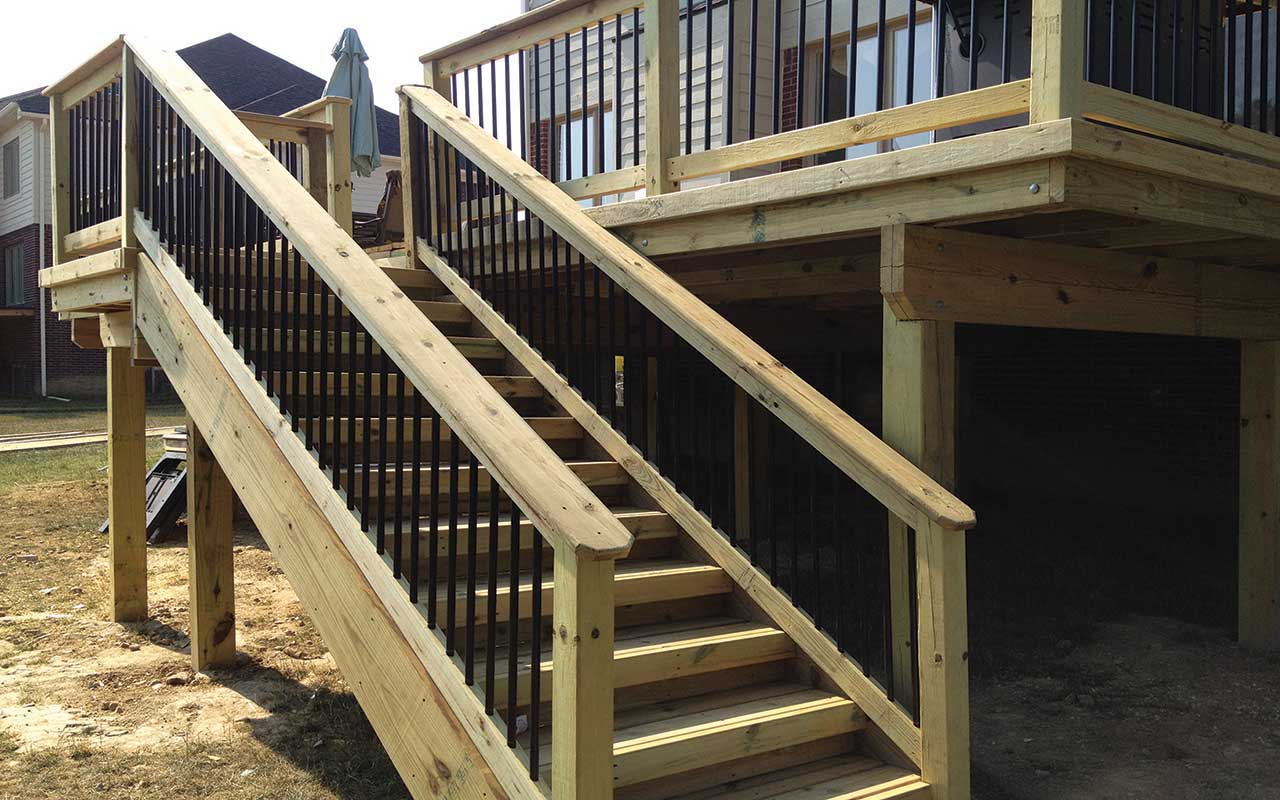 a wooden deck with stairs leading up to it