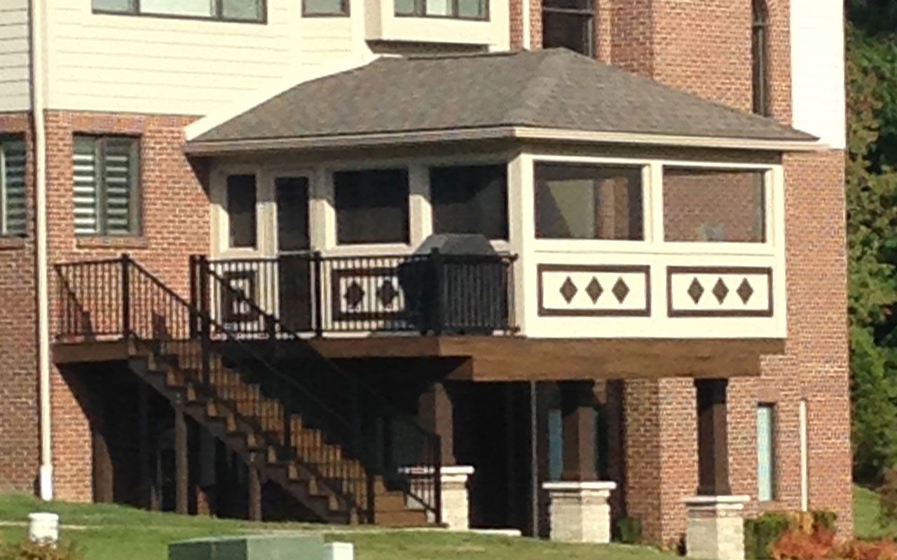 a house with a screened in porch and stairs