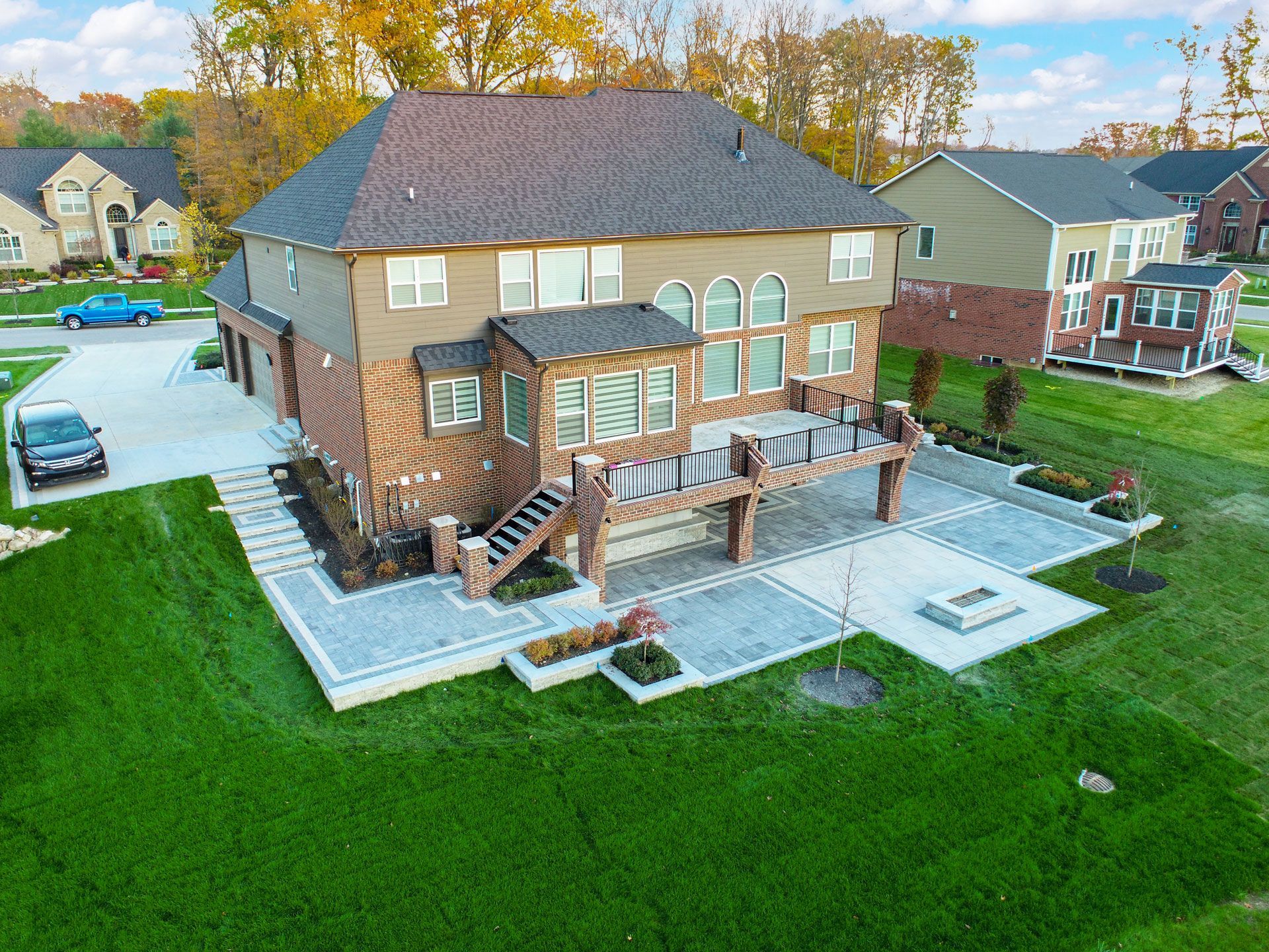 an aerial view of a large house with a large deck in a residential area .