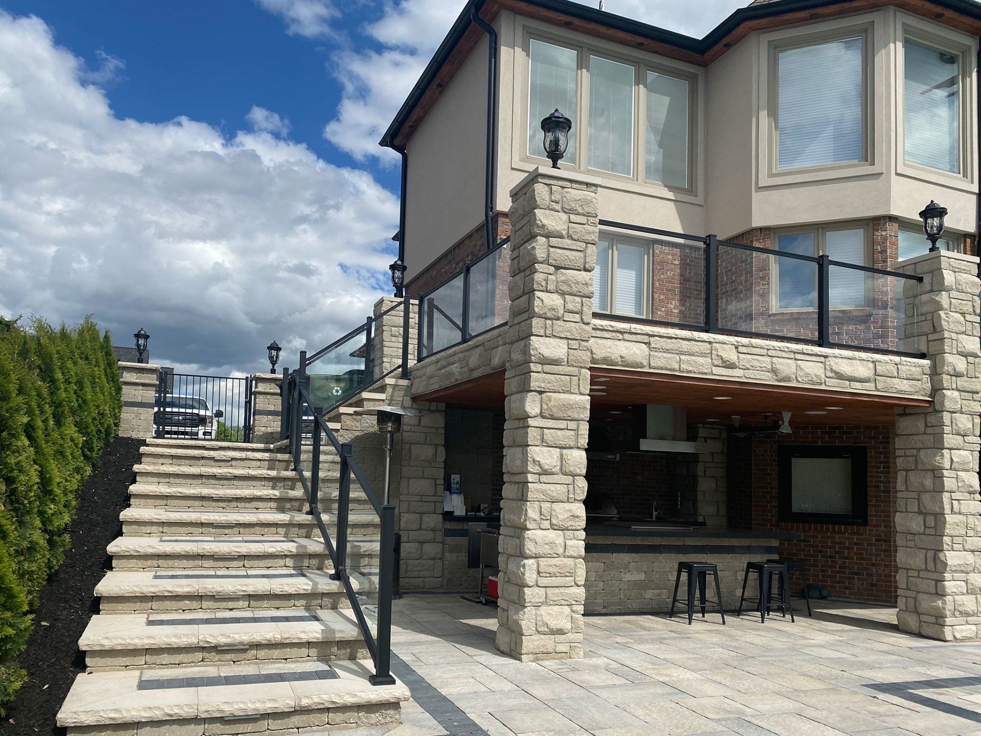a large house with a balcony and stairs leading up to it