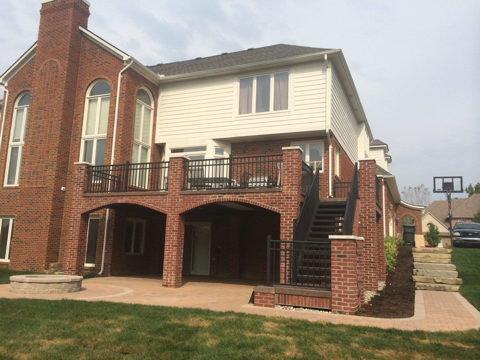 a large brick house with a basketball hoop in front of it
