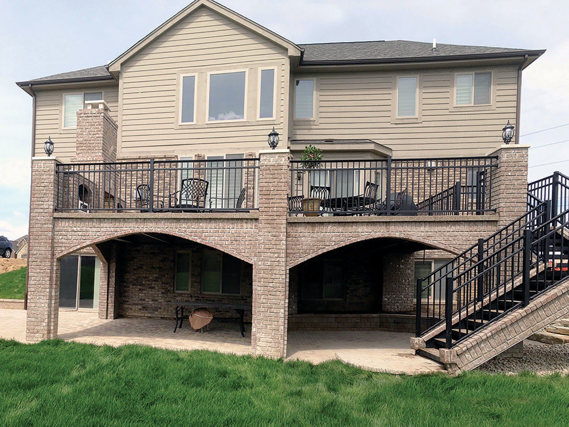 a large house with a large deck and stairs leading up to it .