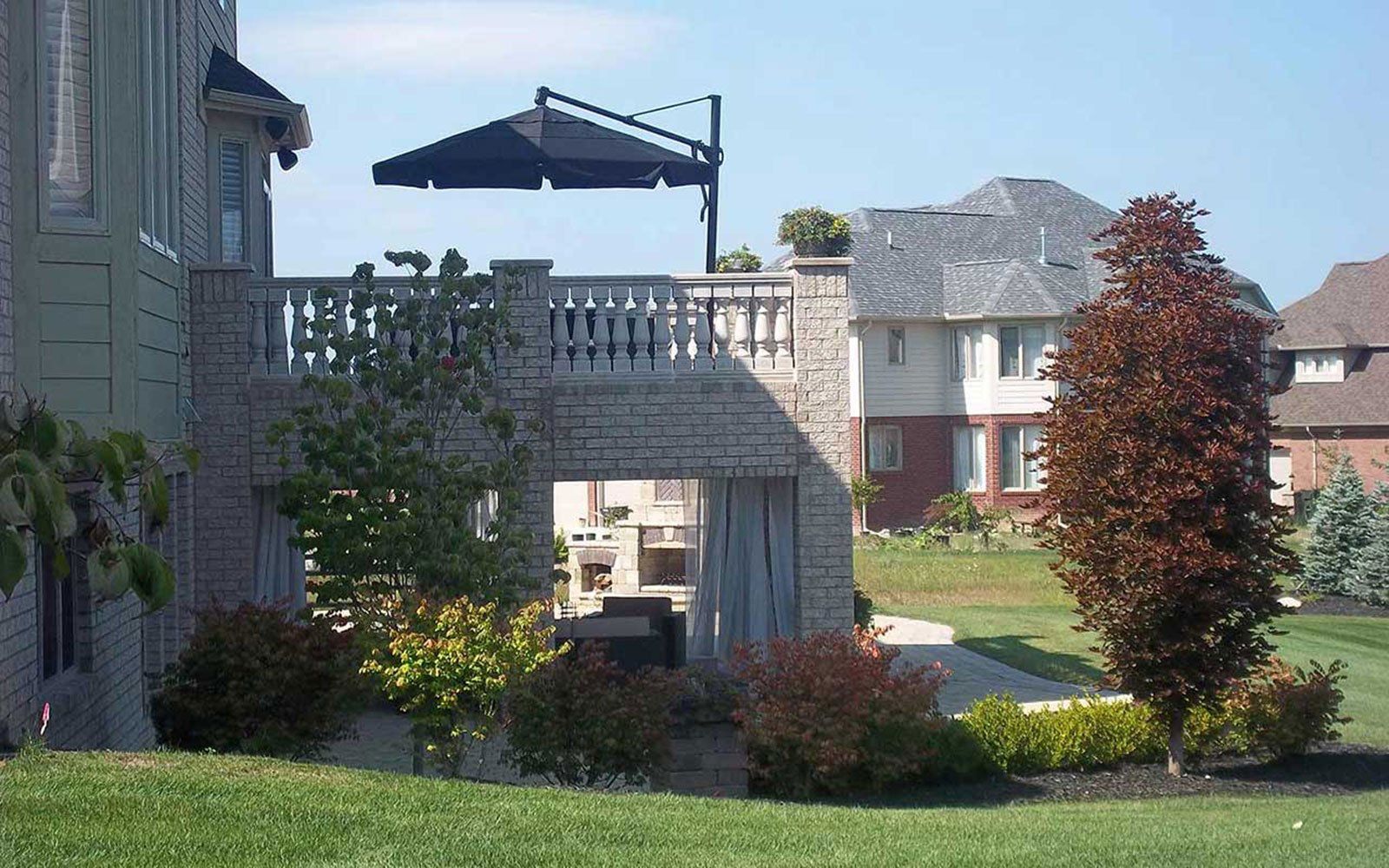 a balcony with a black umbrella on top of it