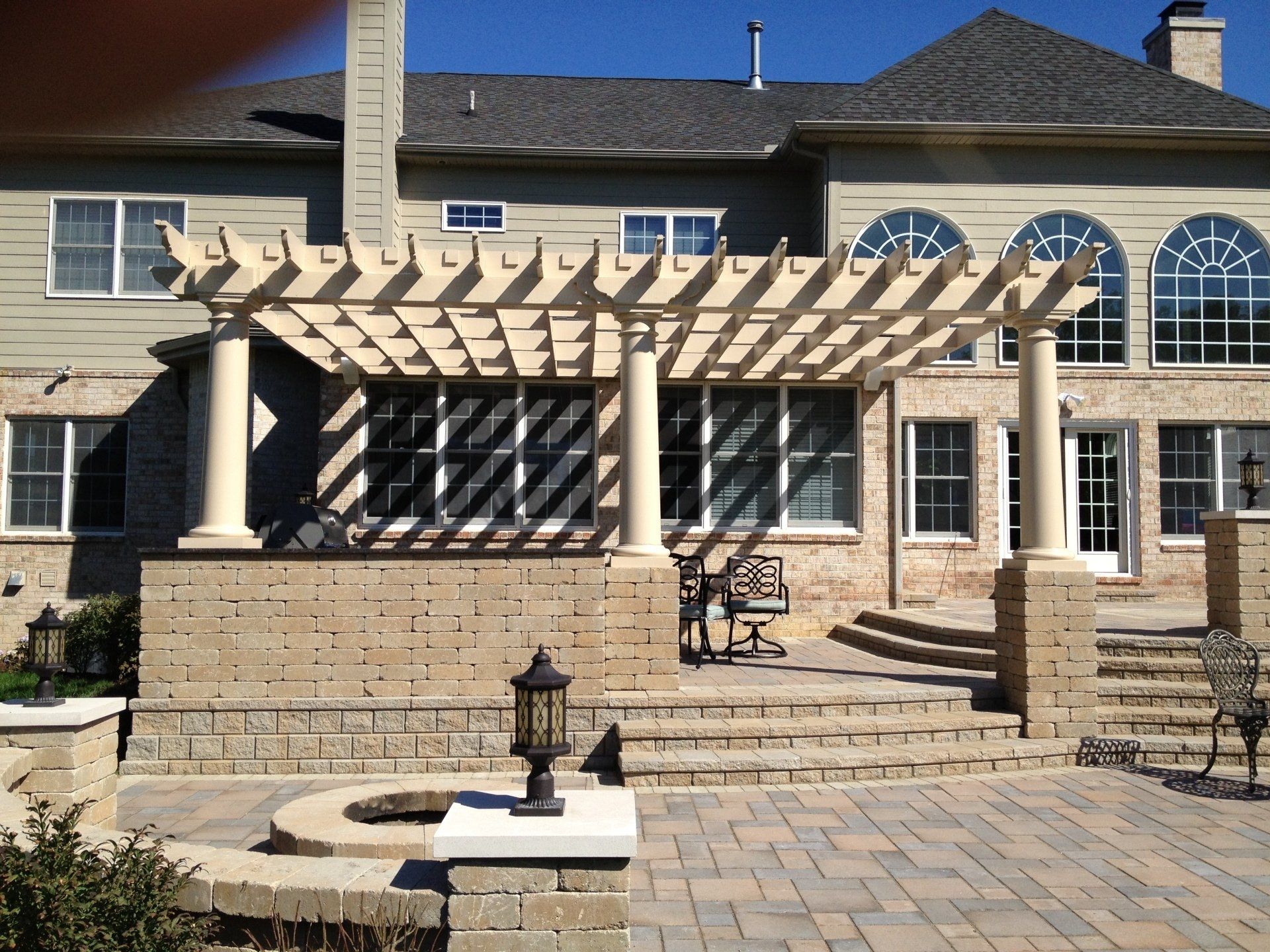 A large house with a pergola in front of it