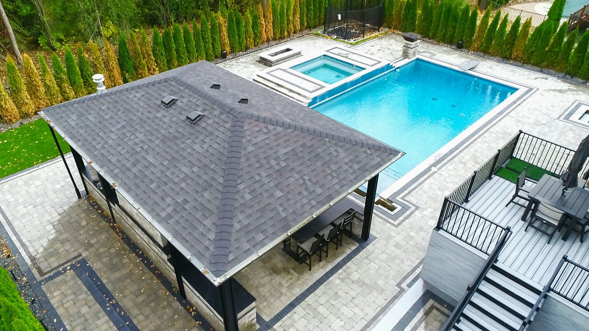 an aerial view of a large swimming pool with a pavilion in the middle of it .