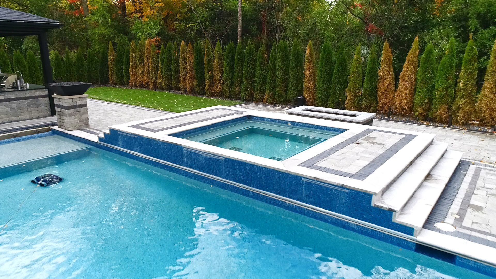 a large swimming pool with a hot tub in the middle of it .