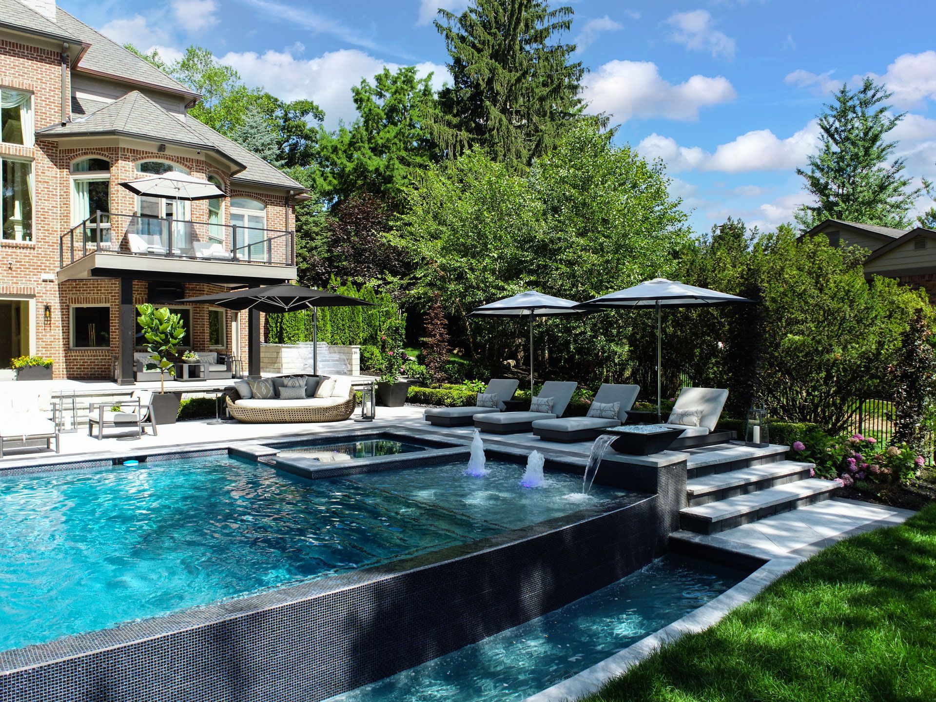 there is a large swimming pool in the backyard of a house .