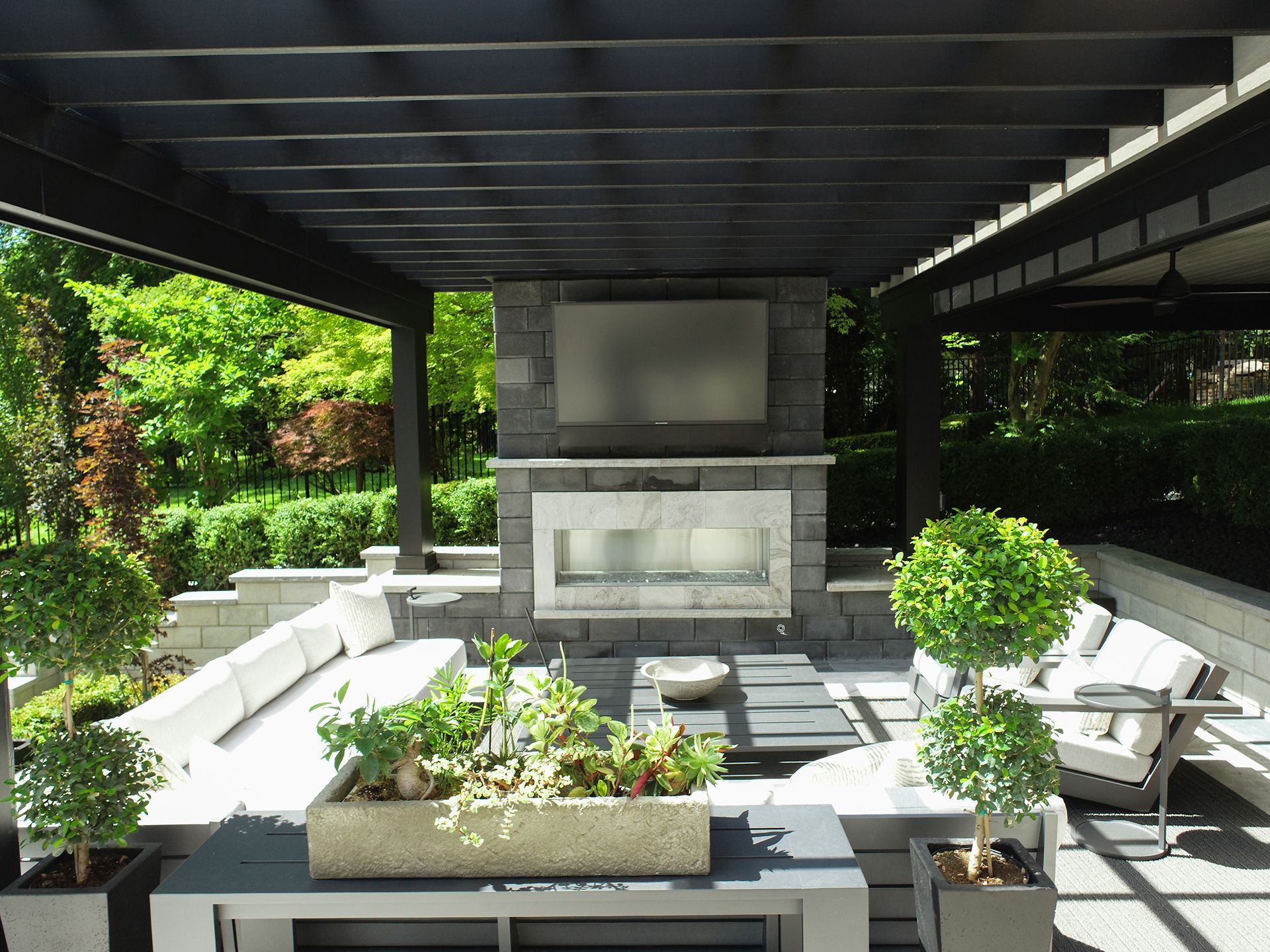 a patio with a fireplace and a flat screen tv