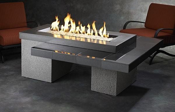 a fire pit is sitting on top of a coffee table