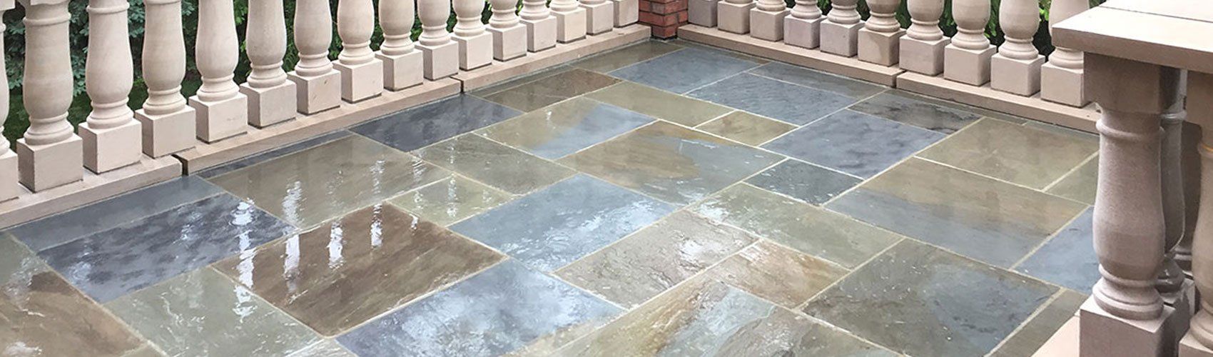 a balcony with a tiled floor and a railing .