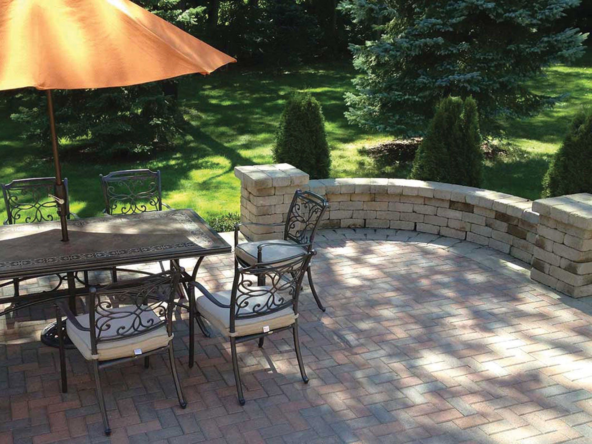 a patio with a table and chairs and an umbrella