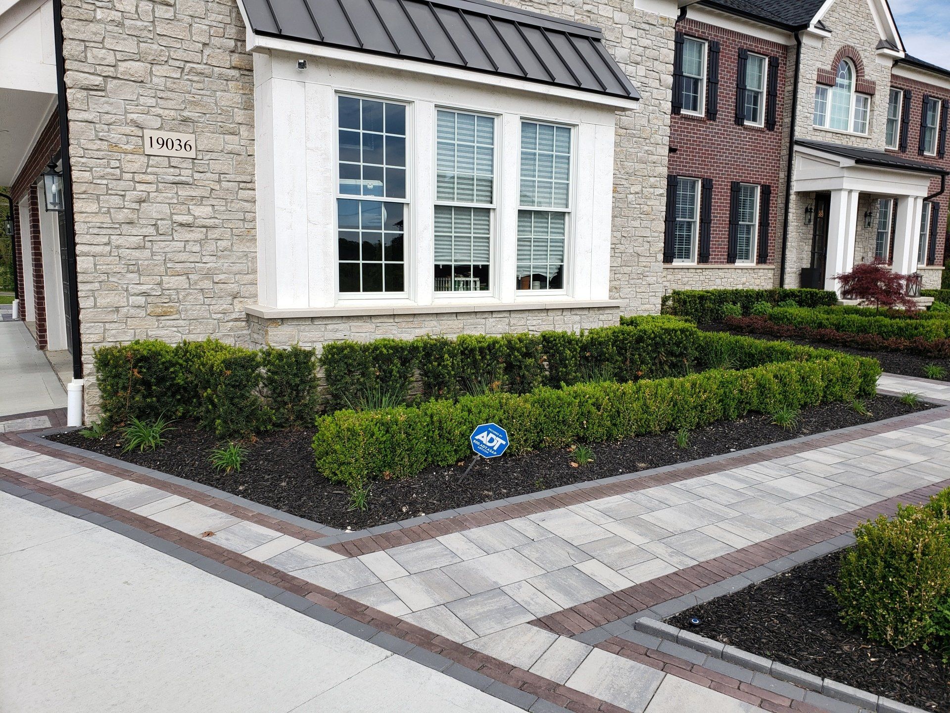 a house with a lot of bushes in front of it .
