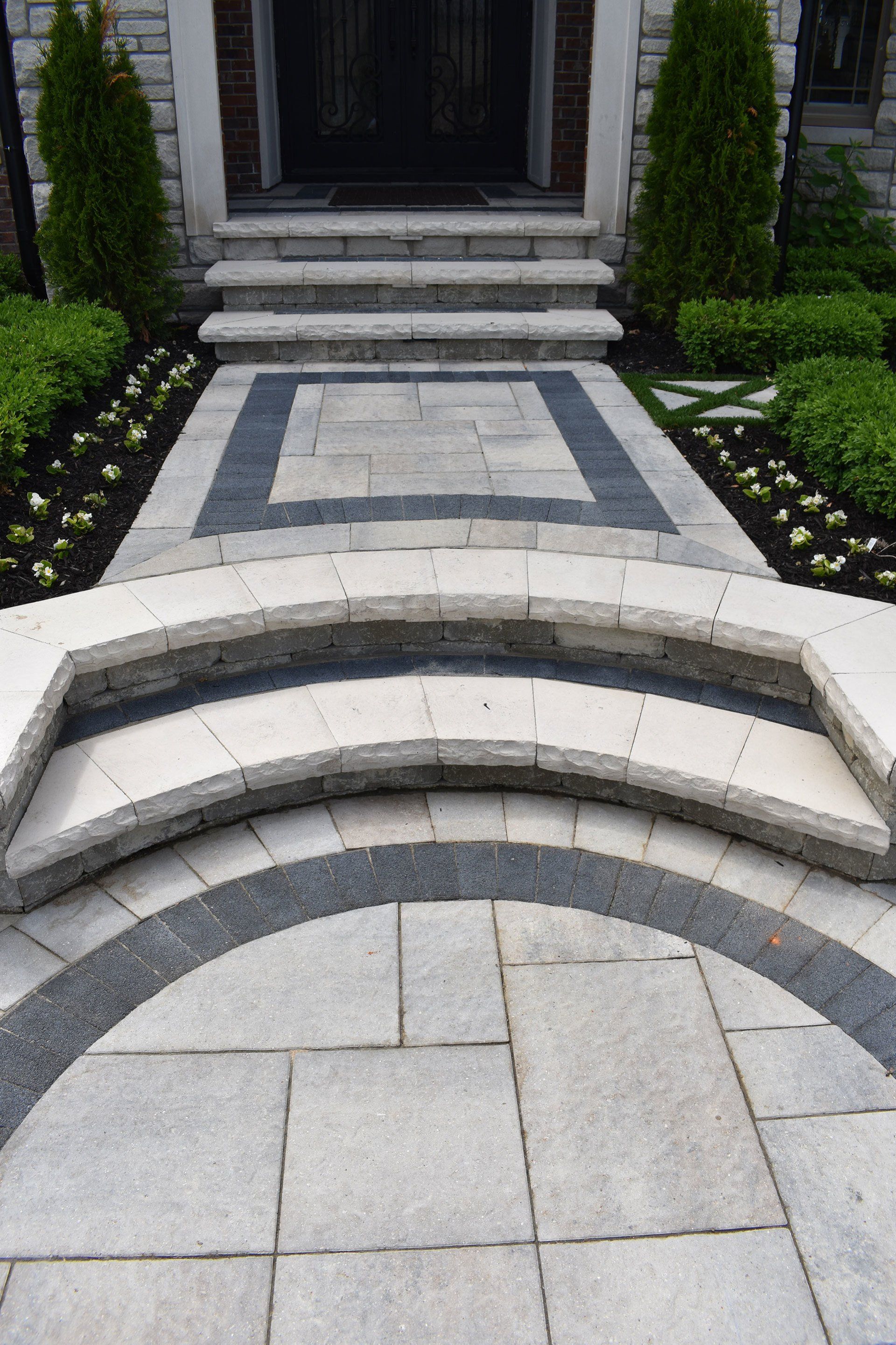 a stone walkway leading to the front door of a house .