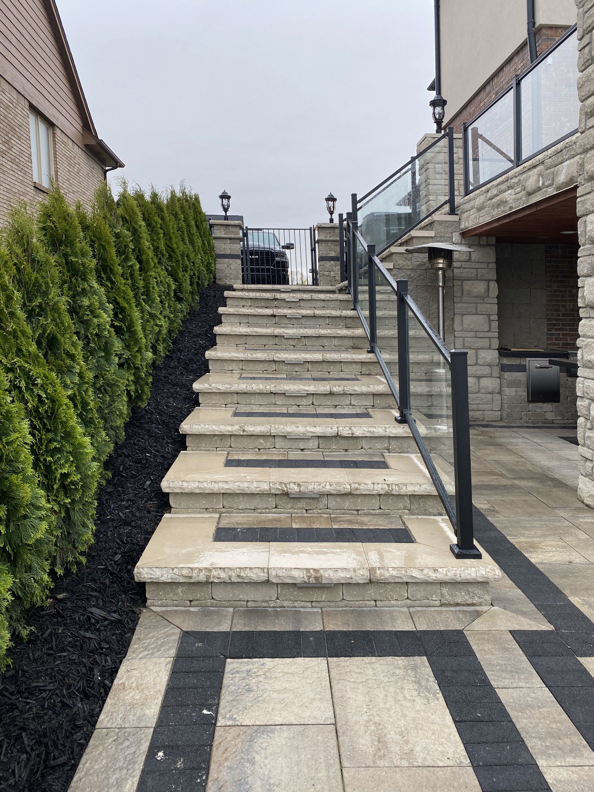 a set of stairs leading up to a house with a glass railing
