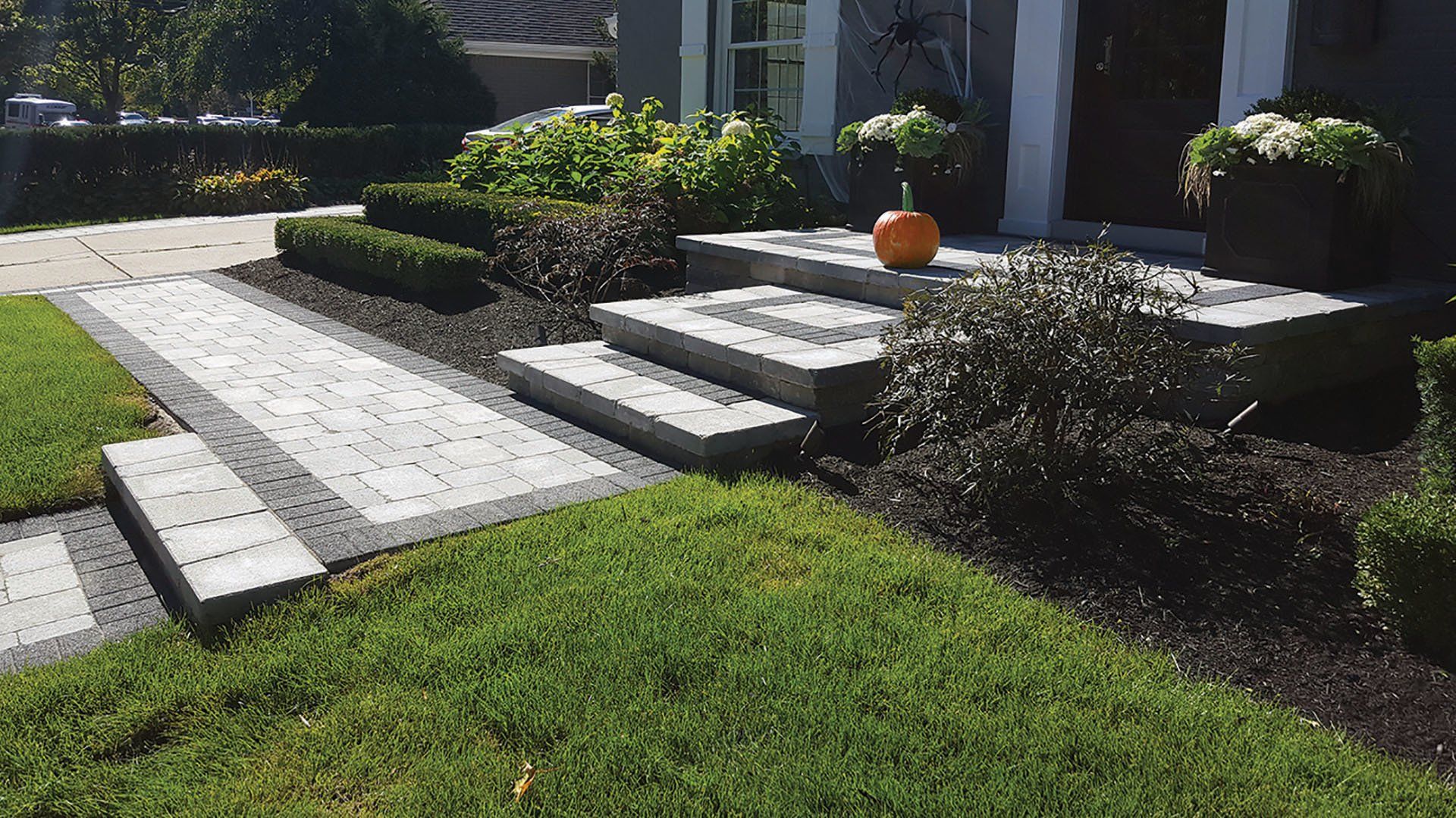 a pumpkin is sitting on the front porch of a house .