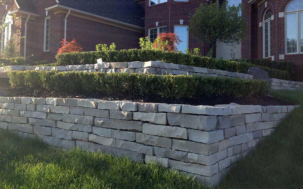 A path going through a grassy area next to a body of water.