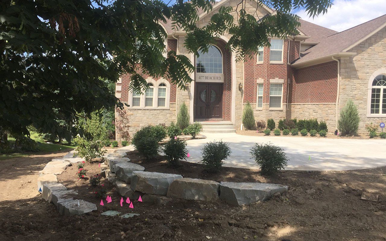 a large brick house with a driveway in front of it