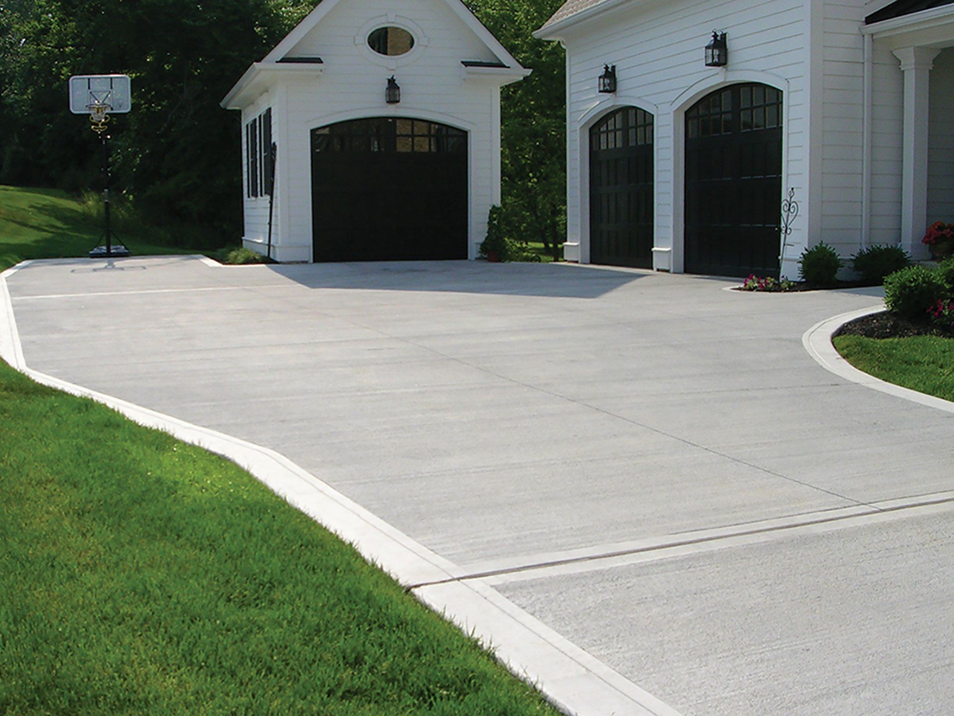 A white house with a basketball hoop in front of it