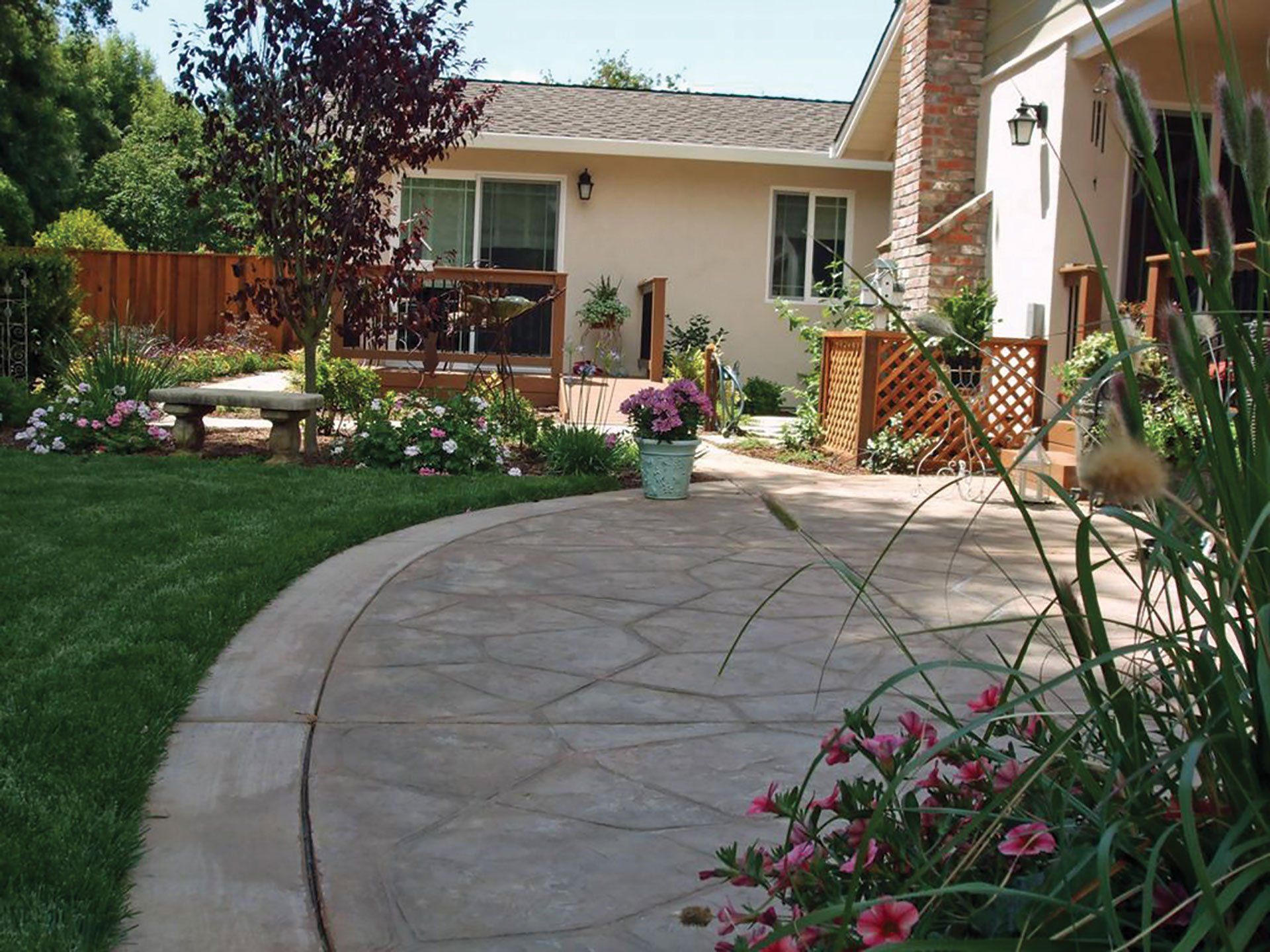 a house with a patio and flowers in front of it