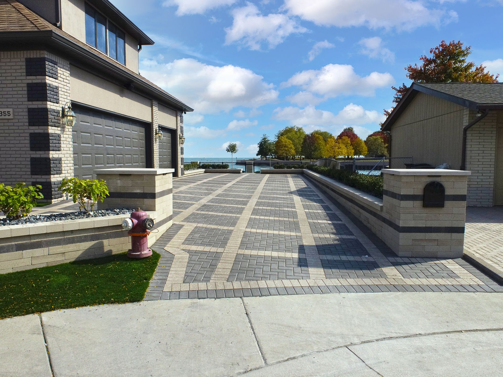 A brick driveway with a fire hydrant in the middle