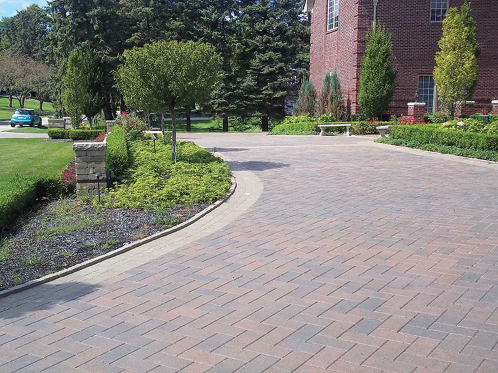a brick driveway with a brick building in the background