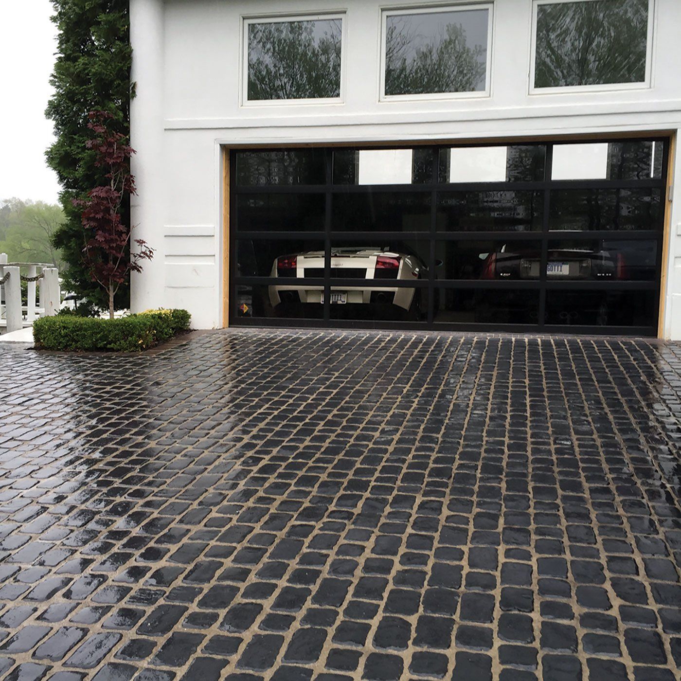 a car is parked in a garage with a glass door